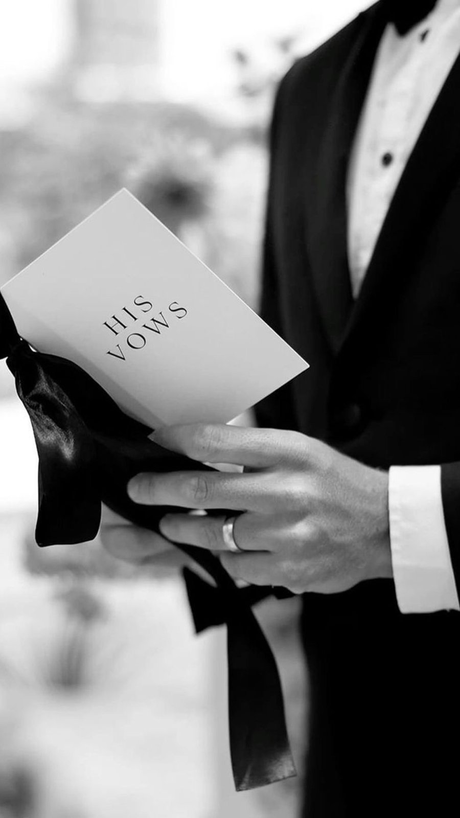 Novio sostiene la tarjeta con sus votos matrimoniales